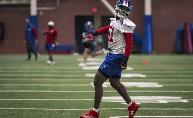 New York Giants linebacker Abdul Carter (51) slows to a stop after catching as pass during the NFL football team's rookie minicamp, Friday, May 9, 2025, in East Rutherford, N.J. (AP Photo/Angelina Katsanis)