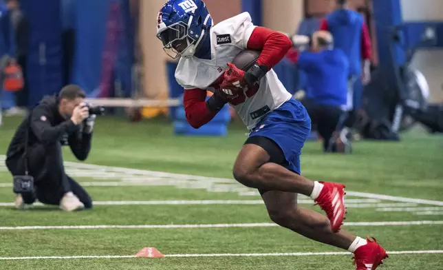 Rookie New York Giants linebacker Abdul Carter (51) runs with a ball during the NFL football team's rookie minicamp, Friday, May 9, 2025, in East Rutherford, N.J. (AP Photo/Angelina Katsanis)