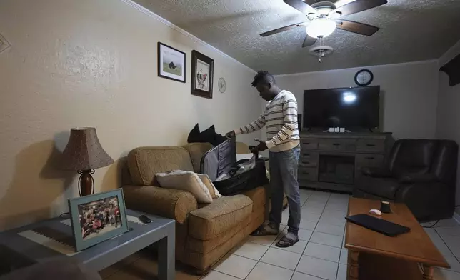 Haitian immigrant Kevenson Jean, a truck driver, packs for a road trip, Tuesday, April 15, 2025, in Panhandle, Texas. (AP Photo/Eric Gay)