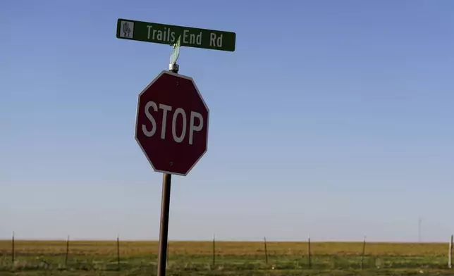 A sign for Trails End Road, home to the JBS meat processing plant, rests on a stop sign, Tuesday, April 15, 2025, in Dumas, Texas. (AP Photo/Eric Gay)