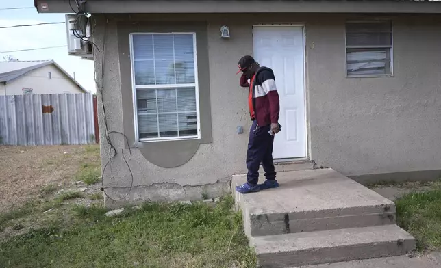 Haitian immigrant Idaneau Mintor, a meat plant worker, stands at the doorway of his one-bedroom apartment he shares with a fellow Haitian, Tuesday, April 15, 2025, in Dumas, Texas. (AP Photo/Eric Gay)
