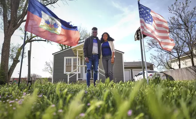 Haitian immigrants Kevenson Jean, a truck driver, and wife Sherlie Jean, a fast food worker, pose for a photo at their rental home, Monday, April 14, 2025, in Panhandle, Texas. (AP Photo/Eric Gay)