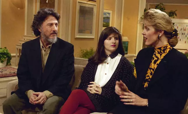 FILE - Actor Dustin Hoffman and Allison Atlas talk with Deborah Norville, at right, while taping a spot on the NBC "Today Show" in New York, February 28, 1990. (AP Photo/Marty Lederhandler, File)