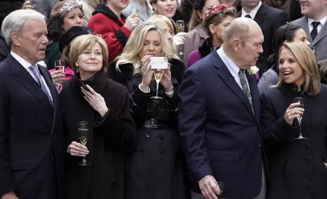 FILE - Former NBC "Today" television program hosts Tom Brokaw, left, Jane Pauley, second left, Deborah Norville, center, and Katie Couric, right, with veteran weatherman Willard Scott, gather for a toast in New York's Rockefeller Center, Jan. 13, 2012. (AP Photo/Richard Drew, File)