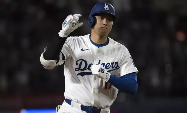 Los Angeles Dodgers' Shohei Ohtani celebrates his solo home run during the sixth inning of a baseball game against the Arizona Diamondbacks in Los Angeles, Monday, May 19, 2025. (AP Photo/Kyusung Gong)