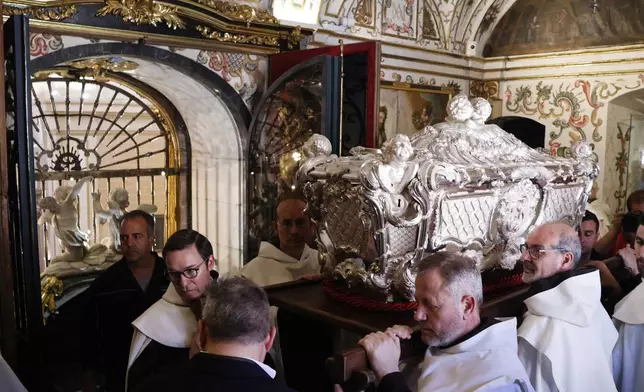 Religious carry in procession the silver casket containing the remains of Saint Teresa of Ávila, the Spanish saint, mystic, and 16th-century religious reformer, before her burial in Alba de Tormes, Salamanca, northwestern Spain, on Monday, May 26, 2025. (Manuel Ángel Laya/Europa Press via AP) **SPAIN OUT**