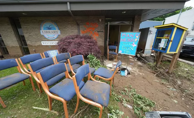 Furniture is placed outside the Westernport Library as clean up continues after flooding on Wednesday, May 14, 2025 in Westernport, Md. (AP Photo/Gene J. Puskar)