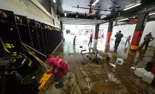 Clean up continues inside the fire station after flooding on Wednesday, May 14, 2025 in Westernport, Md. (AP Photo/Gene J. Puskar)