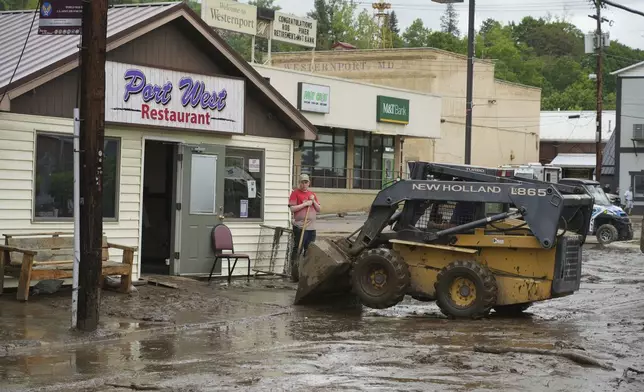 Clean up continues on Main Street after flooding on Wednesday, May 14, 2025 in Westernport, Md. (AP Photo/Gene J. Puskar)