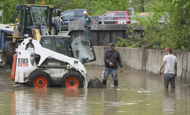 Work crews are trying to drain water as clean up continues after flooding on Wednesday, May 14, 2025 in Westernport, Md. (AP Photo/Gene J. Puskar)