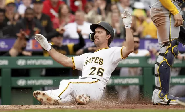 Pittsburgh Pirates' Adam Frazier scores during the sixth inning of a baseball game against the Milwaukee Brewers Sunday, May 25, 2025, in Pittsburgh. (AP Photo/Matt Freed)