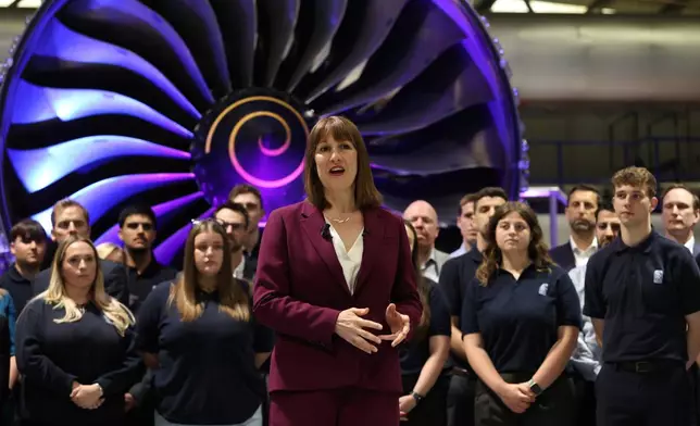 Britain's Chancellor of the Exchequer Rachel Reeves, center, speaks with the media at the Rolls-Royce factory in Derby, England following the announcement from the Office for National Statistics that the U.K. economy grew by 0.7% between January and March, Thursday, May 15, 2025. (Darren Staples/PA via AP)