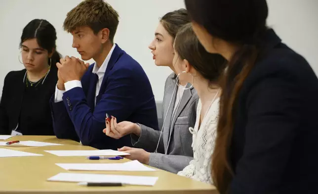 Student Zelda Lerner, center, makes a point during a semifinal round of the National High School Ethics Bowl in Chapel Hill on Sunday, April 13, 2025. (AP Photo/Allen G. Breed)