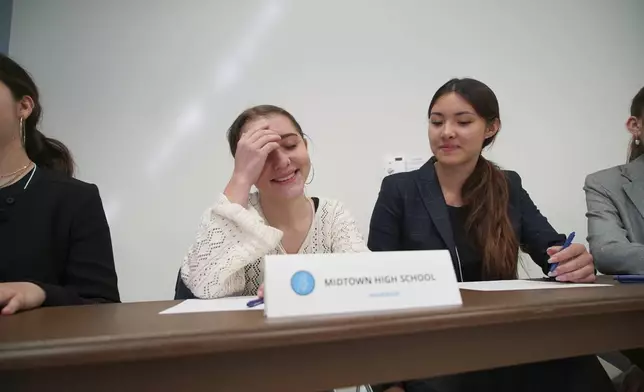 Midtown High School Ethics Bowl teammates Lizzie Lyman, left, and Sloane Crisler prepare for the quarterfinal round at the National High School Ethics Bowl in Chapel Hill, N.C., on Sunday, April 13, 2025. (AP Photo/Allen G. Breed)