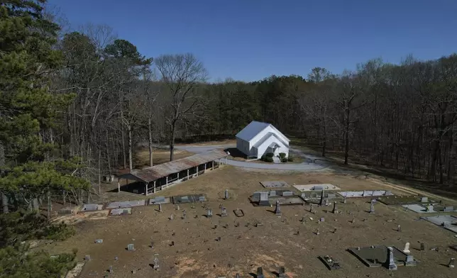 Trees encircle Holly Springs Primitive Baptist Church, which has been a historical meeting site for Sacred Harp singers for generations, in Bremen, Ga., on Sunday, March 23, 2025. (AP Photo/Jessie Wardarski)