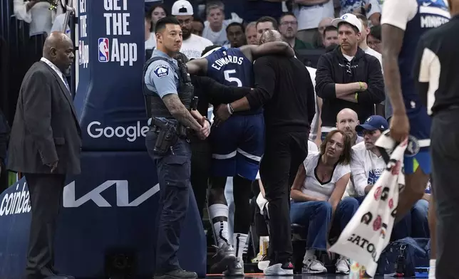 Minnesota Timberwolves guard Anthony Edwards (5) leaves the court after sustaining an injury during the first half of Game 2 of an NBA basketball second-round playoff series against the Golden State Warriors, Thursday, May 8, 2025, in Minneapolis. (AP Photo/Abbie Parr)