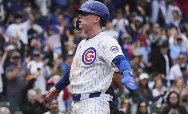 Chicago Cubs' Pete Crow-Armstrong reacts after scoring on a sacrifice fly by Seiya Suzuki, of Japan, during the first inning of a baseball game against the Chicago White Sox in Chicago, Sunday, May 18, 2025. (AP Photo/Nam Y. Huh)