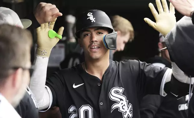 Chicago White Sox's Miguel Vargas celebrates with teammates after hitting a solo home run during the fourth inning of a baseball game against the Chicago Cubs in Chicago, Sunday, May 18, 2025. (AP Photo/Nam Y. Huh)