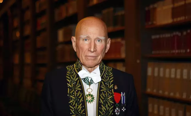 FILE - Photographer Sebastiao Salgado poses for a photo after his election to the French Academy of Fine Arts during a ceremony in Paris, Dec. 6, 2017. Salgado, known for his long-term projects and images of nature and humanity, died at age 81, the Instituto Terra confirmed on Friday, May 23, 2025. (AP Photo/Francois Mori, File)