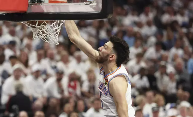 Oklahoma City Thunder forward Chet Holmgren dunks against the Minnesota Timberwolves during the second half of Game 4 of the Western Conference finals of the NBA basketball playoffs Monday, May 26, 2025, in Minneapolis. (AP Photo/Matt Krohn)