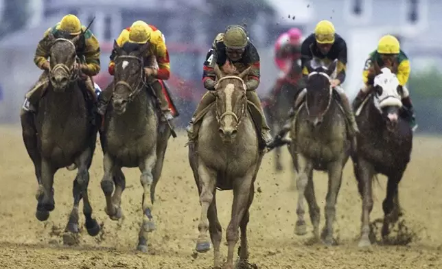 FILE - Red Bullet (4) with jockey Jerry Bailey aboard, center, breaks away from the field in the final stretch to win the 125th running of the Preakness Stakes at Pimlico Race Course in Baltimore, Saturday, May 20, 2000. (AP Photo/Roberto Borea, File)