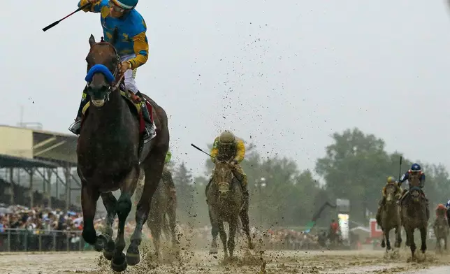 FILE - In this May 16, 2015 file photo, jockey Victor Espinoza, left, celebrates aboard American Pharoah after winning the 140th Preakness Stakes horse race at Pimlico Race Course in Baltimore. (AP Photo/Matt Slocum, File)