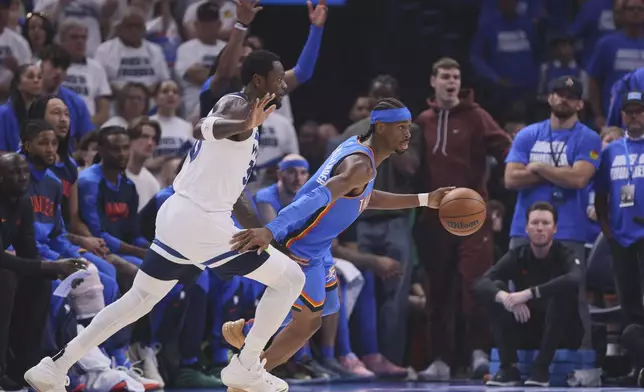 Oklahoma City Thunder guard Shai Gilgeous-Alexander (2), right, works toward the basket as Minnesota Timberwolves forward Julius Randle (30) defends during the first half of Game 5 of the Western Conference finals of the NBA basketball playoffs, Wednesday, May 28, 2025, in Oklahoma City. (AP Photo/Nate Billings)