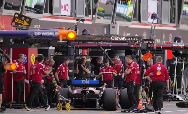 Ferrari driver Charles Leclerc of Monaco gets a pit service during the qualifying session ahead of the Formula One Monaco Grand Prix race at the Monaco racetrack in Monaco, Saturday, May 24, 2025. (AP Photo/Manu Fernandez)