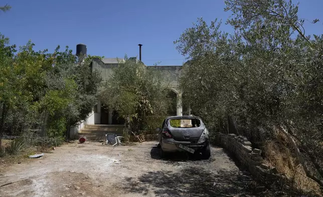 A Palestinian vehicle burnt during an overnight attack by Israeli settlers that left several burnt vehicles and damaged homes, residents said, in the West Bank village of Bruqin, near Salfit Friday, May 23, 2025. (AP Photo/Nasser Nasser)