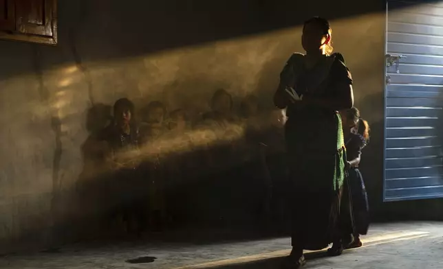 Congregants attend an Indigenous blessing ceremony for Communion wafers that will be taken to a priest to be consecrated before they can be given out, in the Simojovel municipality, Mexico, Saturday, April 26, 2025. (AP Photo/Isabel Mateos)