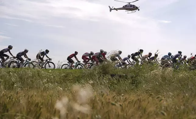 The pack cycles during the fifth stage of the Giro d'Italia cycling race from Ceglie Messapica to Matera, Italy, Wednesday, May 14, 2025. (Fabio Ferrari/LaPresse via AP)