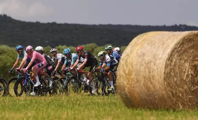 The pack cycles during the fifth stage of the Giro d'Italia cycling race from Ceglie Messapica to Matera, Italy, Wednesday, May 14, 2025. (Fabio Ferrari/LaPresse via AP)