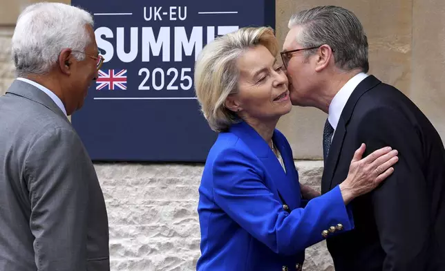Britain's Prime Minister Keir Starmer, right, kisses European Commission President Ursula von der Leyen as she arrives with European Council President Antonio Costa to attend a United Kingdom and European Union summit at Lancaster House, London, Monday, May 19, 2025. (Carl Court/Pool Photo via AP)