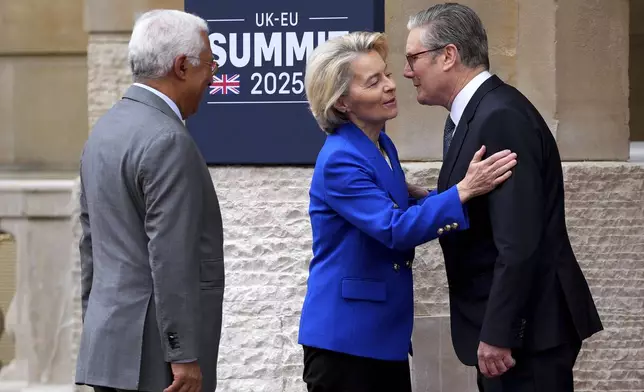 Britain's Prime Minister Keir Starmer, right, greets European Commission President Ursula von der Leyen as she arrives with European Council President Antonio Costa to attend a United Kingdom and European Union summit at Lancaster House, London, Monday, May 19, 2025. (Carl Court/Pool Photo via AP)