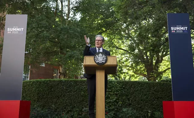 Britain's Prime Minister Keir Starmer speaks during a reception following the UK-EU summit, in London, Monday May 19, 2025. (Hannah McKay/Pool via AP)