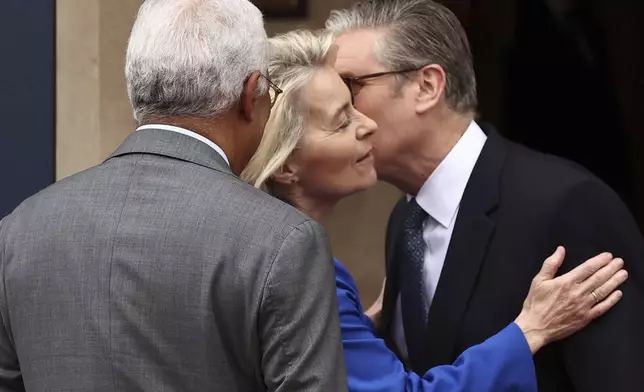 Britain's Prime Minister Keir Starmer, right, kisses European Commission President Ursula von der Leyen as she arrives with European Council President Antonio Costa to attend a United Kingdom and European Union summit at Lancaster House, London, Monday, May 19, 2025. (Henry Nicholls/Pool Photo via AP)