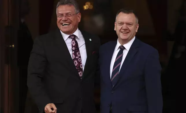 Britain's Paymaster General and Minister for the Cabinet Office for the Constitution and European Relations Nick Thomas-Symonds greets EU Commissioner for Trade and Economic Security, Maros Sefcovic, right, as he arrives to attend the UK-EU Summit at Lancaster House, in London, Monday, May 19, 2025. (Henry Nicholls/Pool Photo via AP)