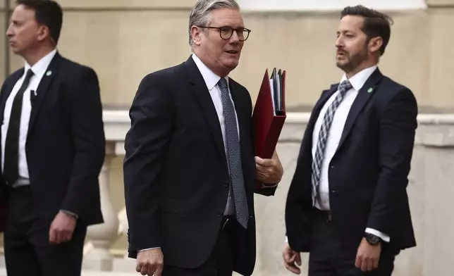 Britain's Prime Minister Keir Starmer, center, arrives to attend the UK-EU Summit at Lancaster House, in London, Monday, May 19, 2025. (Henry Nicholls/Pool Photo via AP)