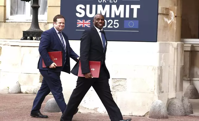 Britain's Foreign Secretary David Lammy, foreground, arrives to attend the UK-EU Summit at Lancaster House, in London, Monday, May 19, 2025. (Henry Nicholls/Pool Photo via AP)