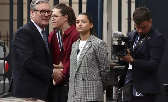 Britain's Prime Minister Keir Starmer, left, arrives to attend the UK-EU Summit at Lancaster House in London, Monday, May 19, 2025. (Henry Nicholls/Pool Photo via AP)