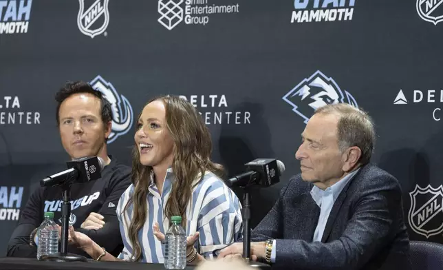 Chairman of Smith Entertainment Group Ryan Smith and co-founder Ashley Smith join NHL Commissioner Gary Bettman, from left, as they announce the Utah Mammoth as the new name and branding identity of Utah's NHL franchise, Wednesday, May 7, 2025, in Salt Lake City. (AP Photo/Melissa Majchrzak)
