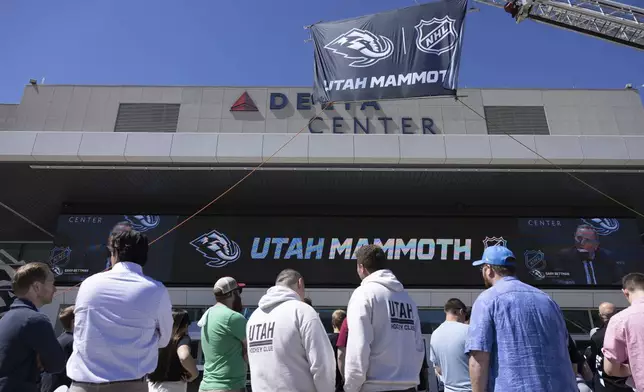 Fans watch outside Delta Center watch the live press conference announcing Utah Mammoth as the new name and branding identity of Utah's NHL franchise, Wednesday, May 7, 2025, in Salt Lake City. (AP Photo/Melissa Majchrzak)