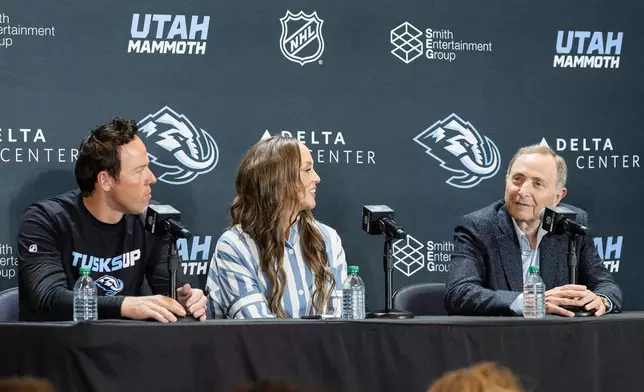 Chairman of Smith Entertainment Group Ryan Smith, Co-Founder Ashley Smith and NHL Commissioner Gary Bettman, from left, announce the Utah Mammoth as the new name and branding identity of Utah's NHL franchise, Wednesday, May 7, 2025, in Salt Lake City. (AP Photo/Melissa Majchrzak)