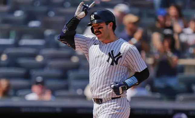 New York Yankees' Austin Wells gestures as he reaches home plate after hitting a home run during the fifth inning of a baseball game against the Tampa Bay Rays, Saturday, May 3, 2025, in New York. (AP Photo/Frank Franklin II)