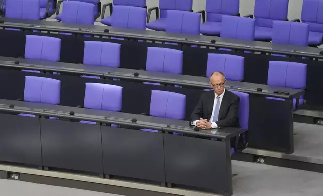 Chancellor Friedrich Merz sits on the government bench after taking the oath of office at the German federal parliament, Bundestag, at the Reichstag building in Berlin, Germany, Tuesday, May 6, 2025. (AP Photo/Markus Schreiber)