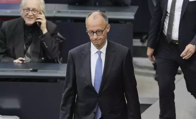 Friedrich Merz, center, reacts after he fell short of votes need to be chancellor in first round vote at the parliament Bundestag in Berlin, Tuesday, May 6, 2025. (AP Photo/Markus Schreiber)