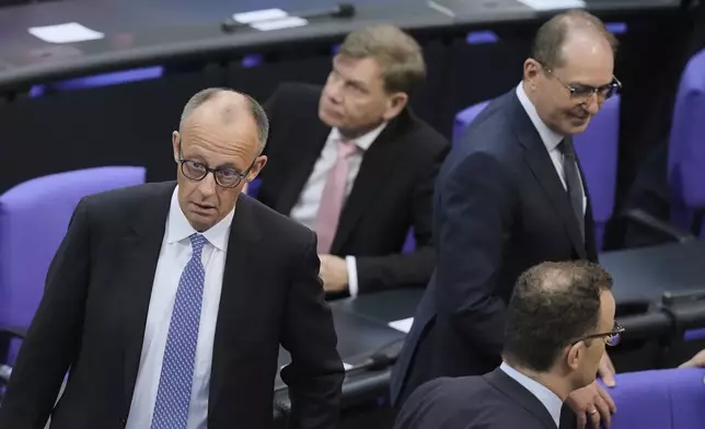 Friedrich Merz, left, reacts after he fell short of votes need to be chancellor in first round vote at the parliament Bundestag in Berlin, Tuesday, May 6, 2025. (AP Photo/Markus Schreiber)
