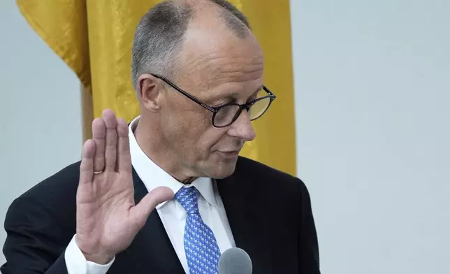 Friedrich Merz takes the oath of office in front of Parliament President Julia Kloeckner after being elected new Chancellor at the German federal parliament, Bundestag, at the Reichstag building in Berlin, Germany, Tuesday, May 6, 2025..(AP Photo/Ebrahim Noroozi)