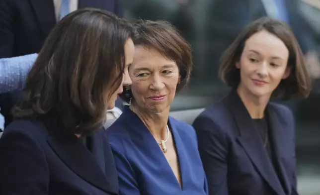 Charlotte Merz, centre, wife of Chancellor-designate Merz, and her daughters Carola Clüsener, left, and Constanze Merz during the election of a new Chancellor at the parliament Bundestag in Berlin, Tuesday, May 6, 2025. (AP Photo/Markus Schreiber)
