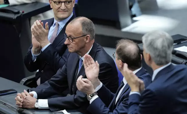 Leader of the Christian Democrats Friedrich Merz is applauded after being elected new chancellor at the German federal parliament, Bundestag, at the Reichstag building in Berlin, Germany, Tuesday, May 6, 2025. (AP Photo/Ebrahim Noroozi)